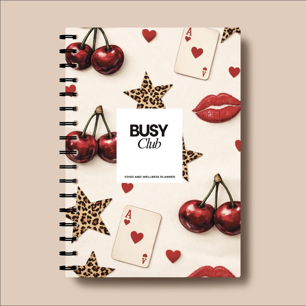 Notebook cover with cherries, cards, and stars on a beige background