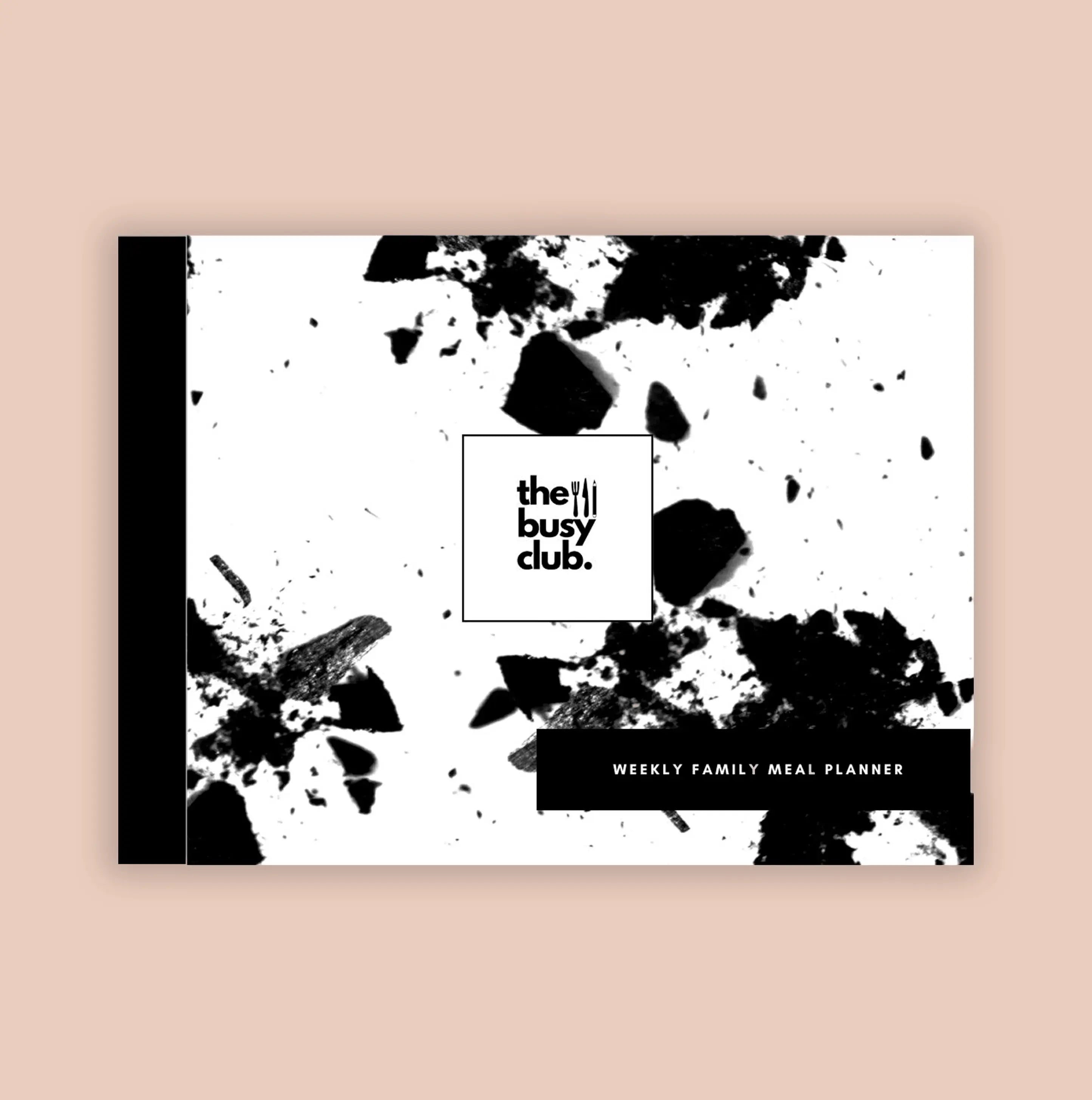 Meal planner cover with black splashes and 'the busy club' branding on a beige background