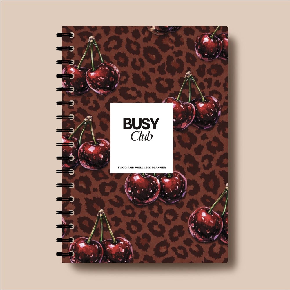 Notebook with cherry and leopard print design on a beige background