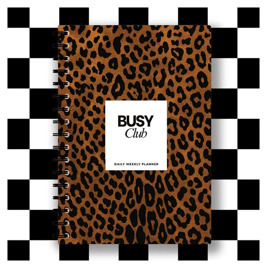 Leopard print planner with 'BUSY Club' label on a black and white checkered background