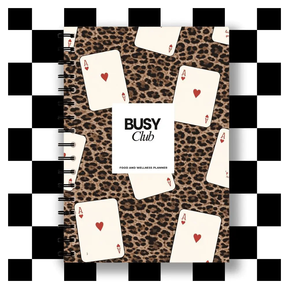 Leopard print planner with playing cards on a checkered background