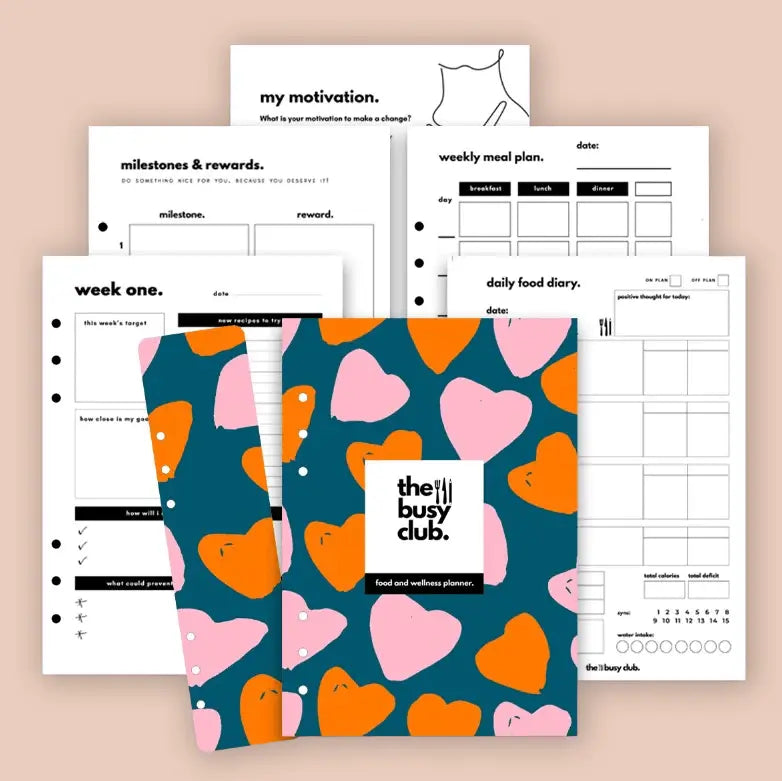 Planner with heart pattern cover and various pages on a beige background