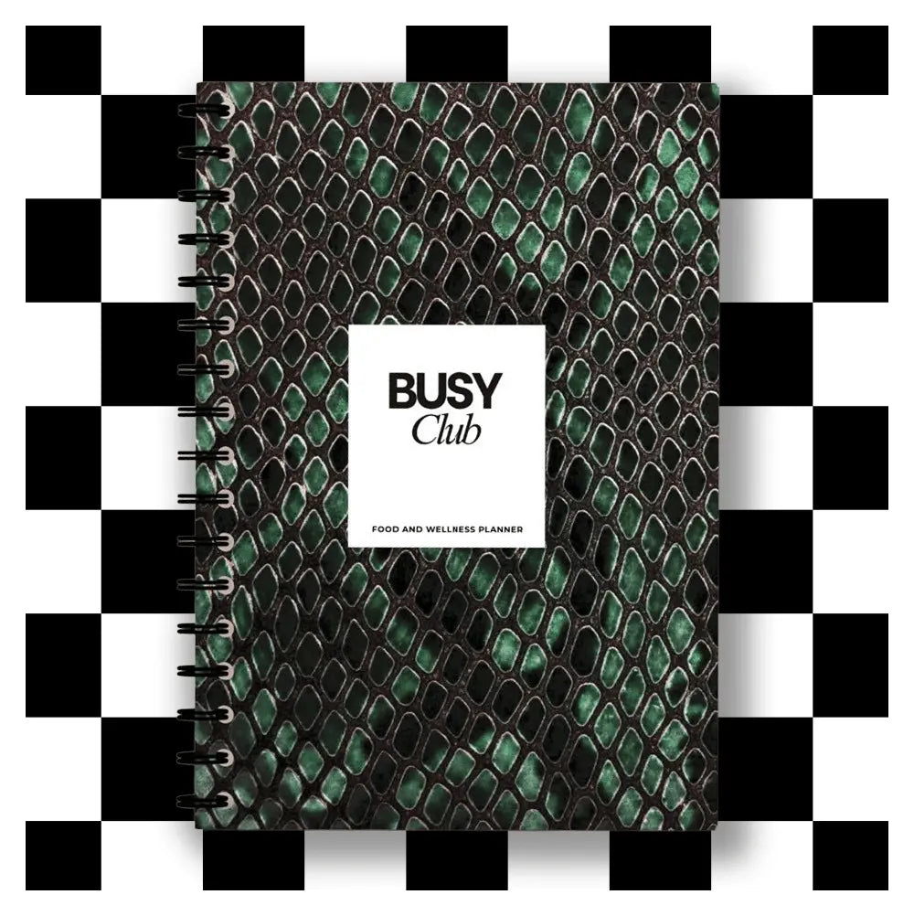 Planner with green snake skin pattern and 'BUSY Club' label on a checkered background